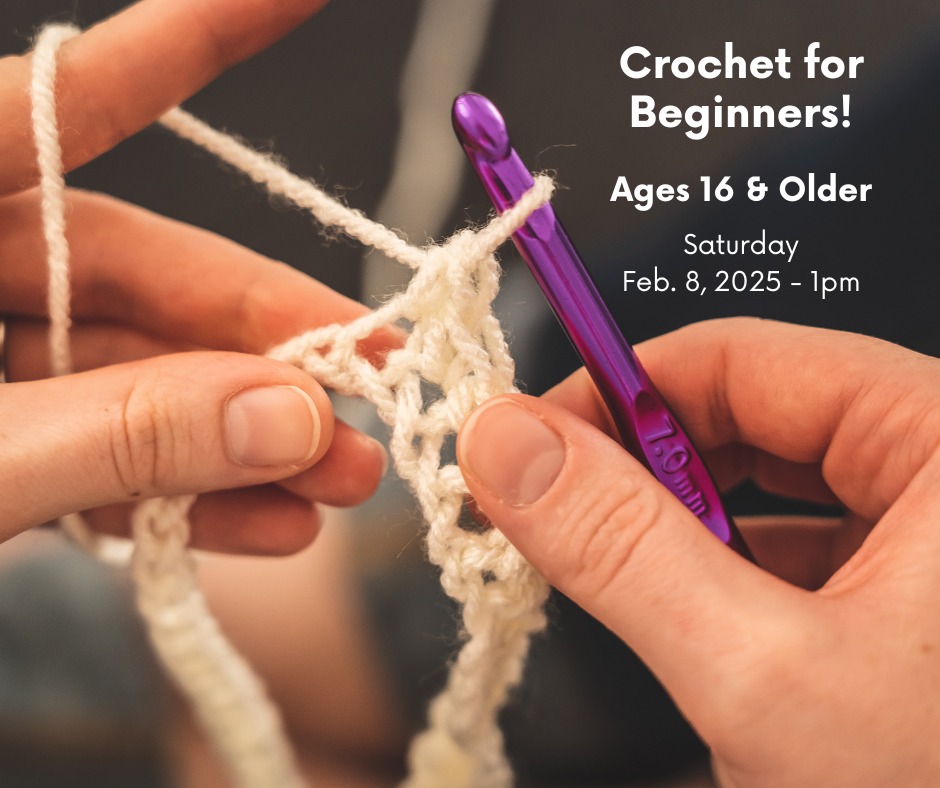 two hands, one holding a purple crochet hook, both holding white yarn